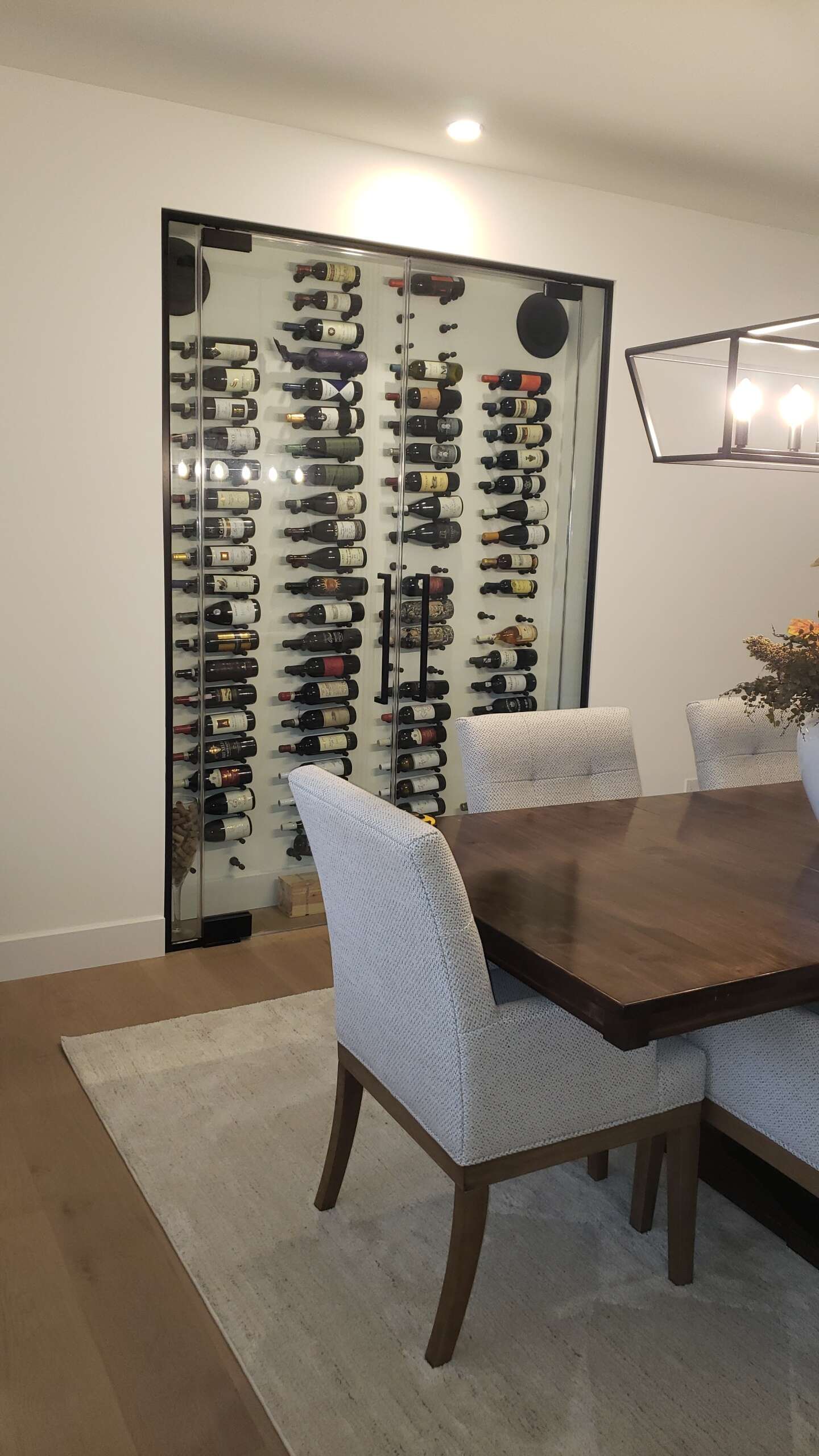 Custom recessed wine cellar display and cooling system.