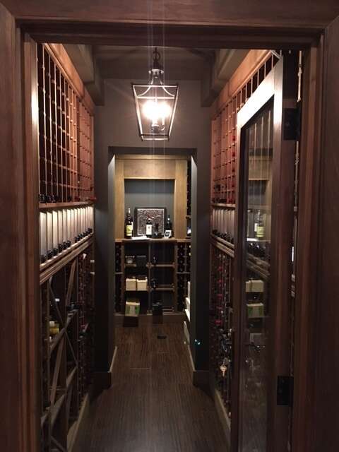 Featuring VWC custom wine racking and door unit with display and highlight lighting systems.