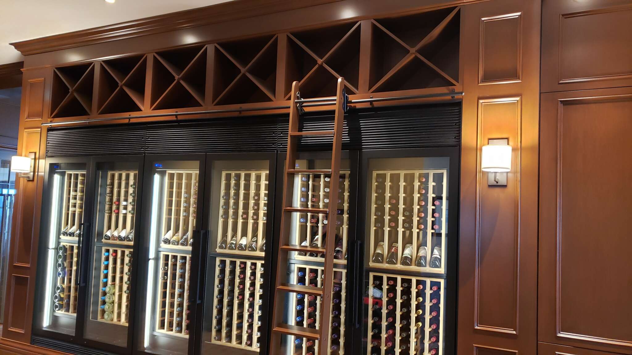 Featuring custom wine cabinets (millwork by others), independent cooling  and display systems