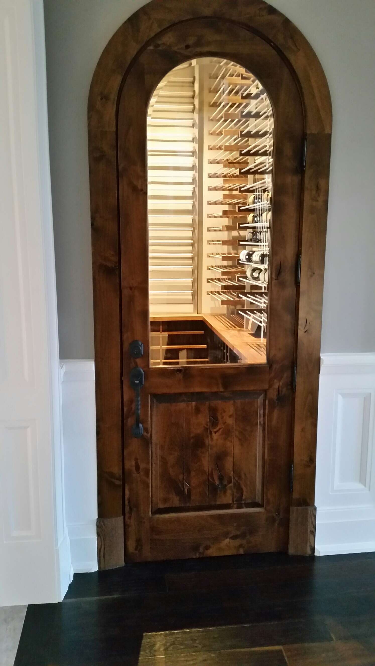Custom wine room featuring ductable cooling system, EVO racking system and cabinetry.
